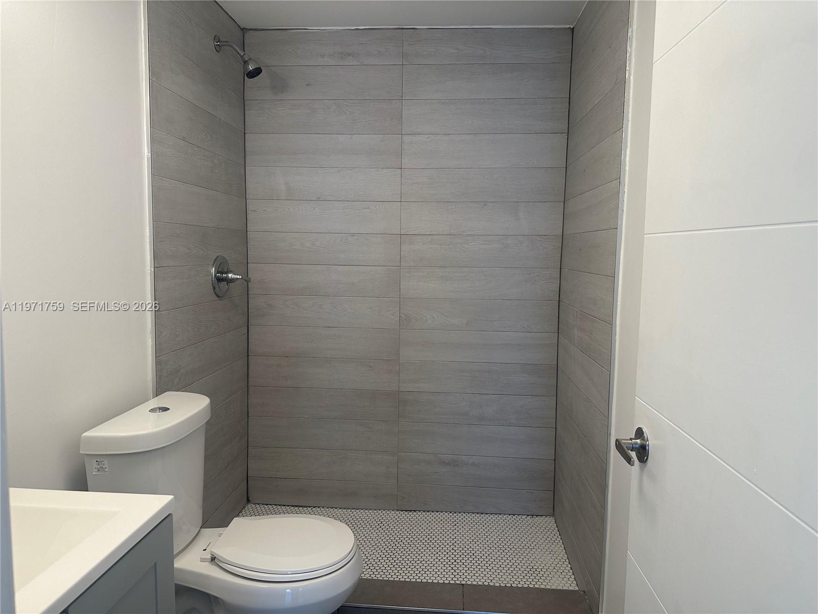 2206 Simms Street Hollywood, FL 33020 - Photo 7 of 23 a bathroom with a toilet and a shower