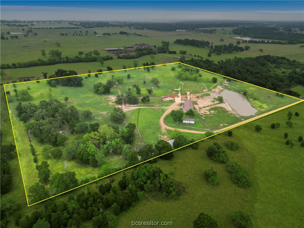an aerial view of a golf course with a lake view