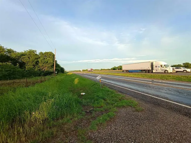 a view of green field with wooden fence