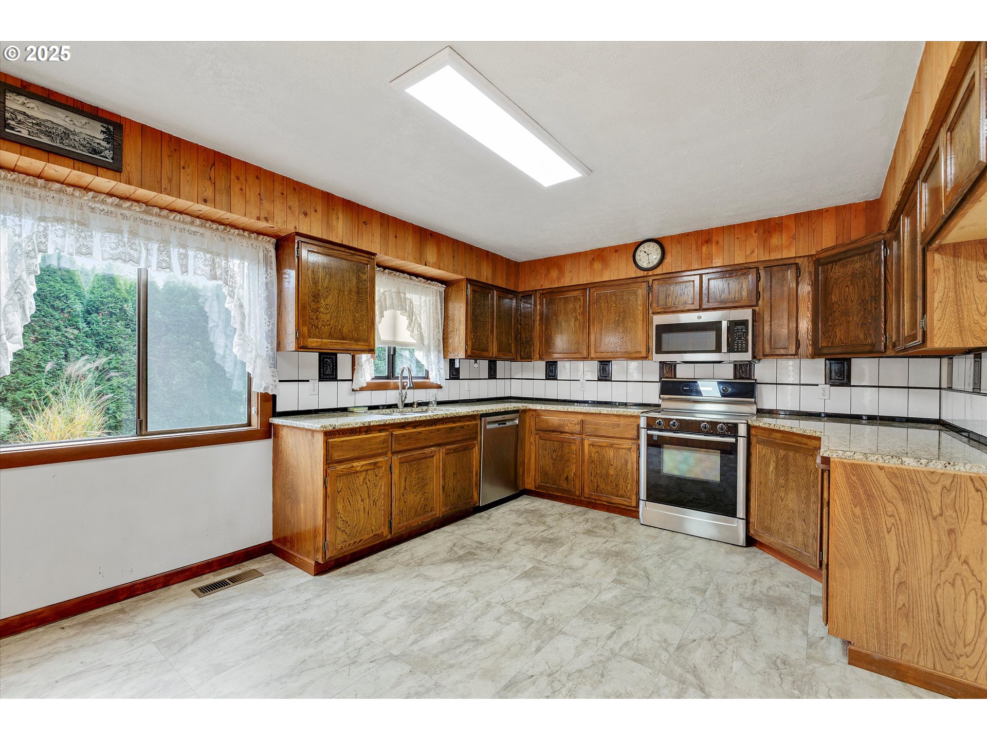 25164 South Springwater Road Estacada, OR 97023 - Photo 4 of 43 a kitchen with stainless steel appliances granite countertop a refrigerator a sink dishwasher a stove with wooden cabinets and dining table