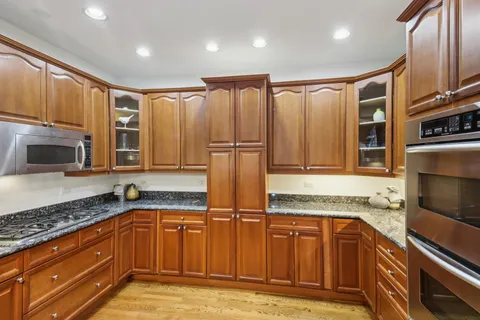 a kitchen with stainless steel appliances granite countertop a sink and a granite counter tops