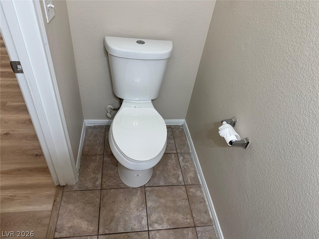 3962 Coyote Ridge Court Las Vegas, NV 89129 - Photo 15 of 35 Functional commode provides essential facilities within a well-maintained space.