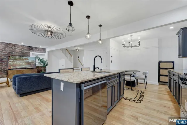 a open kitchen with stainless steel appliances granite countertop a stove and cabinets