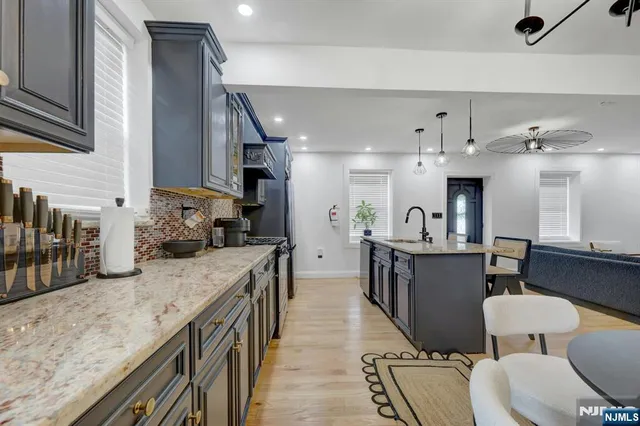 a kitchen with granite countertop lots of counter top space and stainless steel appliances
