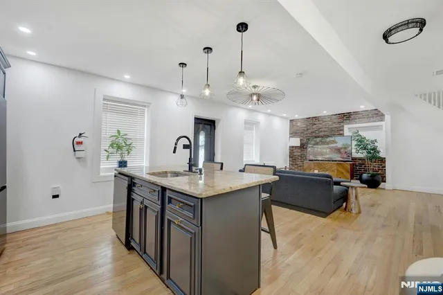 a view of living room with kitchen island furniture and wooden floor