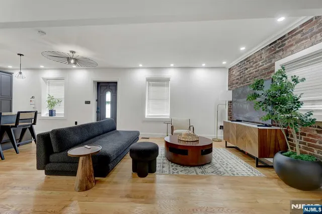 a living room with furniture and a potted plant