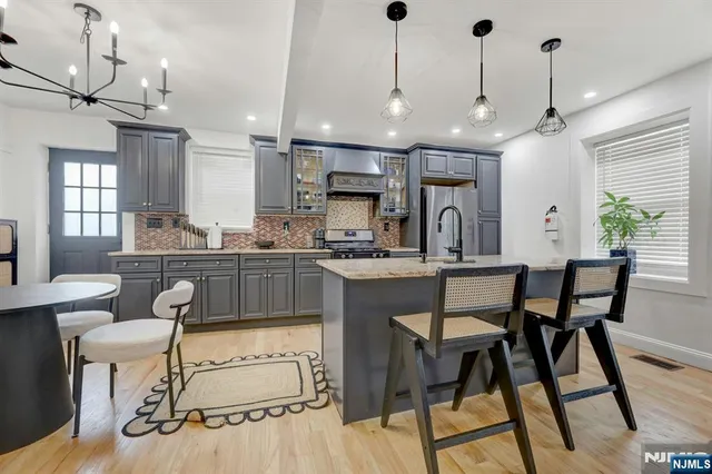 a kitchen with granite countertop lots of counter top space dining table and stainless steel appliances