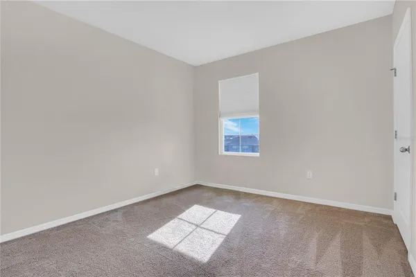 an empty room with a empty space and a window