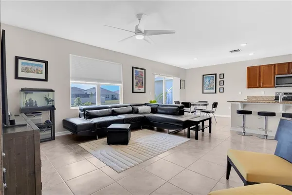 a living room with furniture a rug and a window