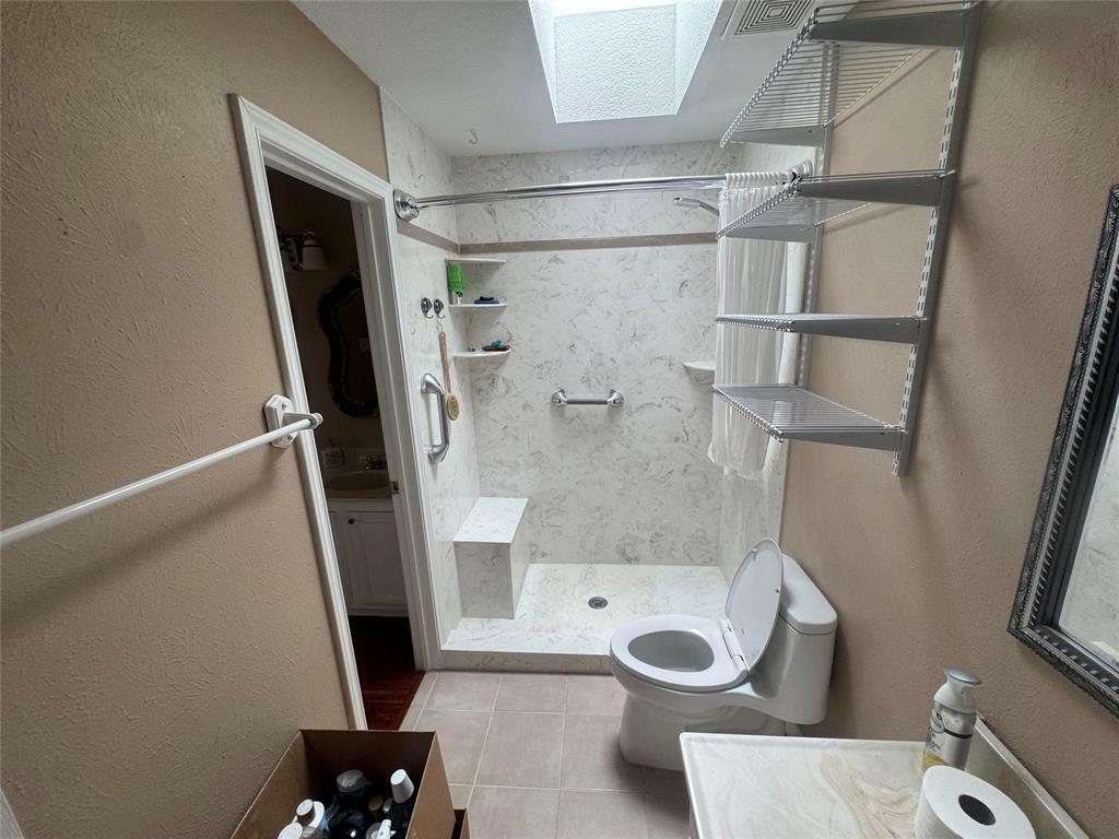 4649 Misty Ridge Drive Fort Worth, TX 76137 - Photo 6 of 25 a bathroom with a granite countertop shower and toilet