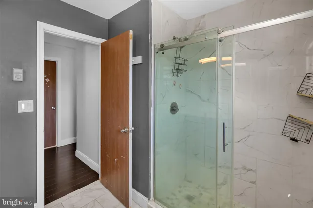 a bathroom with a shower and a sink