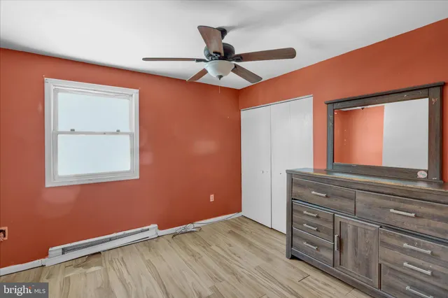 a view of a livingroom with a ceiling fan and a dresser