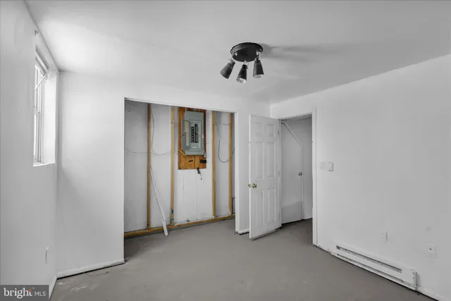 a view of a livingroom with a chandelier fan and closet area