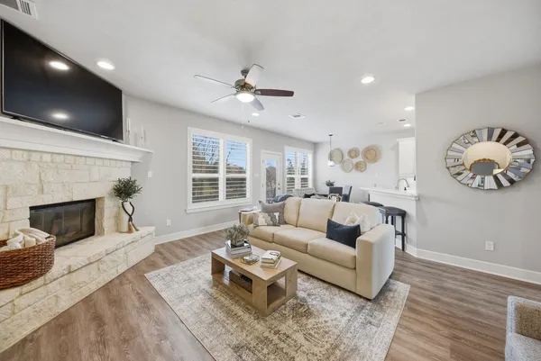 a living room with furniture a fireplace and a flat screen tv