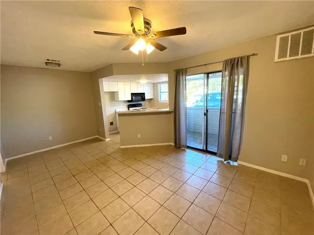 a view of a kitchen with a sink and a refrigerator