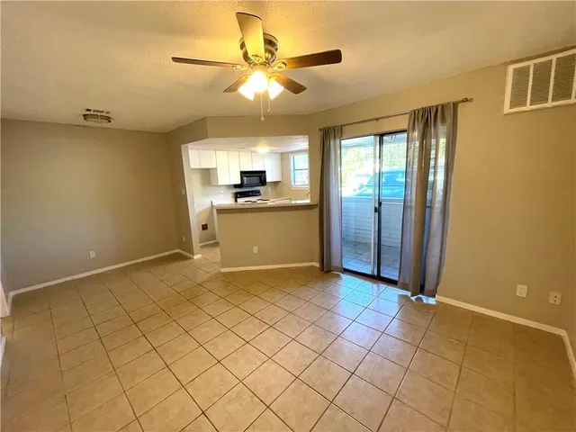 a view of a kitchen with a sink and a refrigerator
