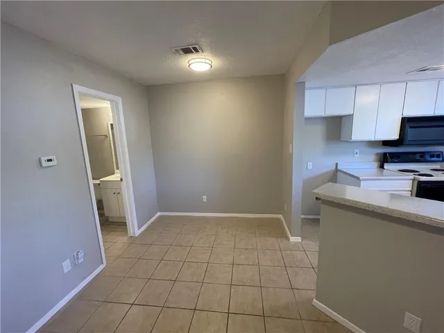 a view of a kitchen with a sink and dishwasher stove top oven with wooden floor