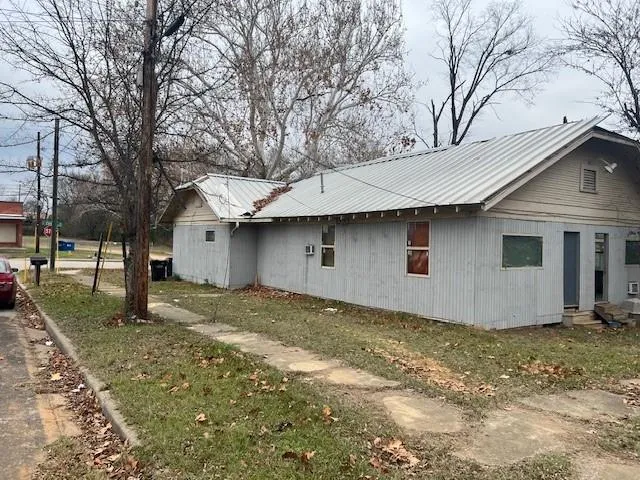a house that has a tree in front of it