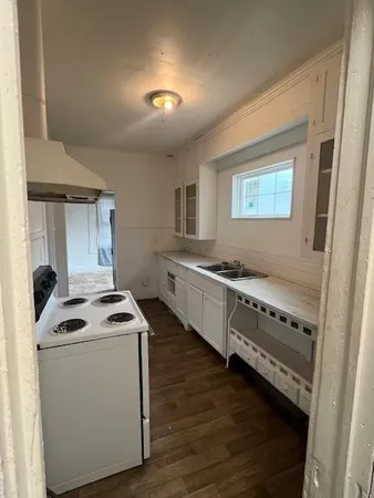 a kitchen that has a sink and a stove