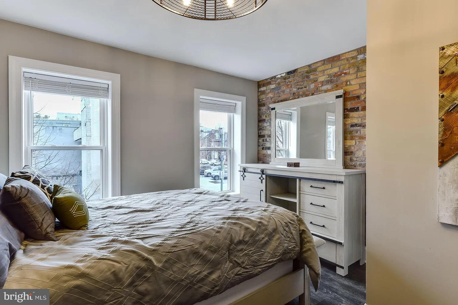 734 Light Street, Unit 2 Baltimore, MD 21230 - Photo 11 of 17 a bedroom with a bed and a mirror