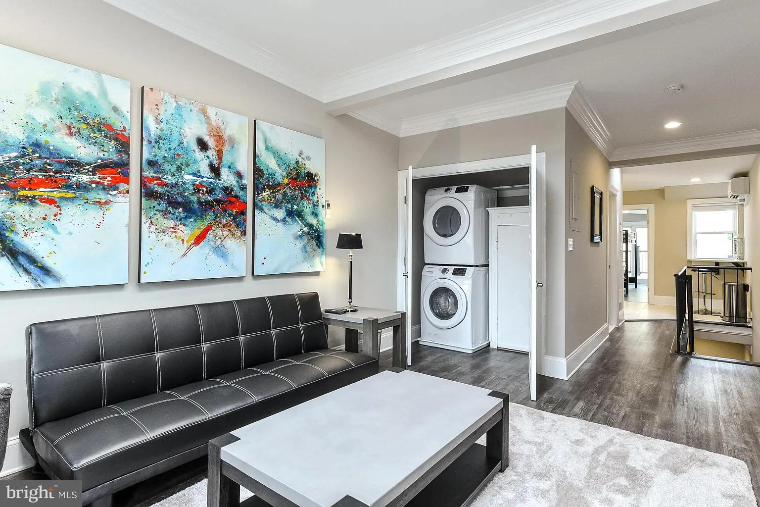 734 Light Street, Unit 2 Baltimore, MD 21230 - Photo 3 of 17 a living room with furniture a flat screen tv and a floor to ceiling window
