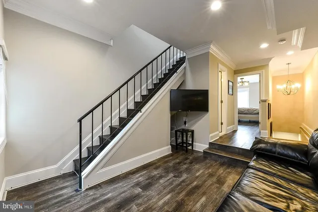 a view of a hallway with wooden floor and staircase