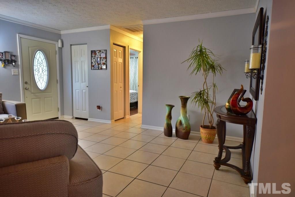 8301 Wynewood Court Raleigh, NC 27616 - Photo 11 of 22 a bedroom with a bed a potted plant and a dresser