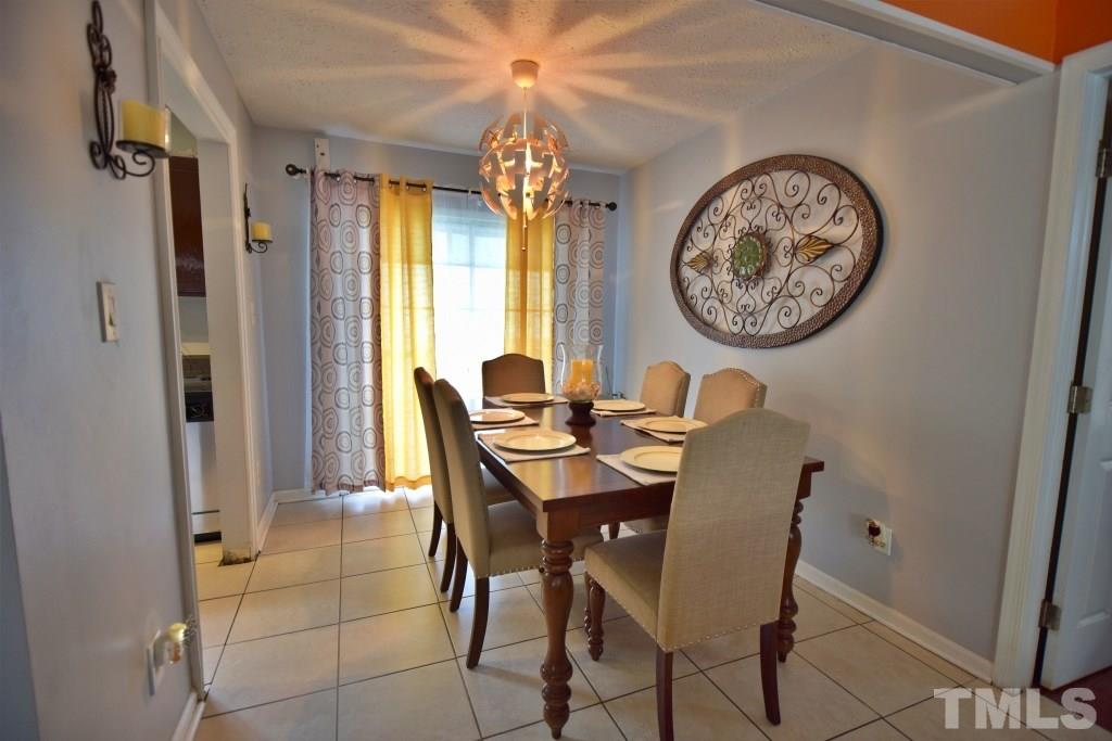 8301 Wynewood Court Raleigh, NC 27616 - Photo 13 of 22 a view of a dining room with furniture and a large window