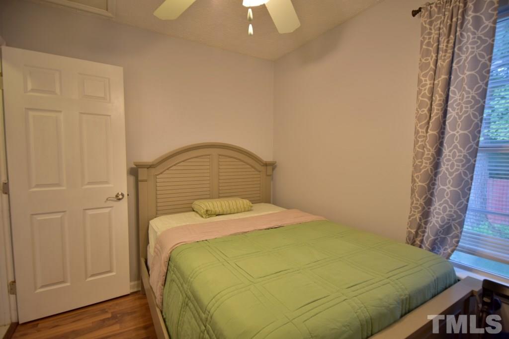 8301 Wynewood Court Raleigh, NC 27616 - Photo 21 of 22 a bedroom with a bed and wooden floor