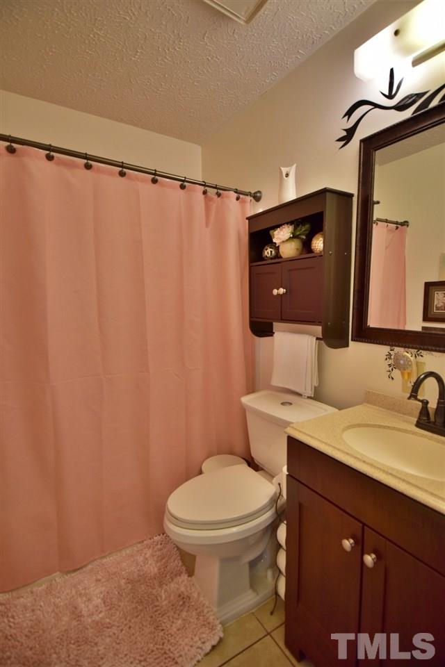8301 Wynewood Court Raleigh, NC 27616 - Photo 22 of 22 a bathroom with a toilet a sink and curtain