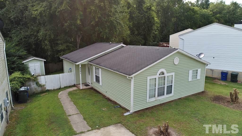 8301 Wynewood Court Raleigh, NC 27616 - Photo 6 of 22 a aerial view of a house next to a yard with large trees