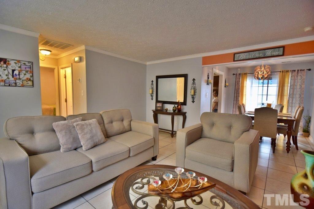 8301 Wynewood Court Raleigh, NC 27616 - Photo 9 of 22 a living room with furniture and a large window