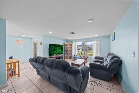 a bedroom with a balcony a bed and a large window with the outer view