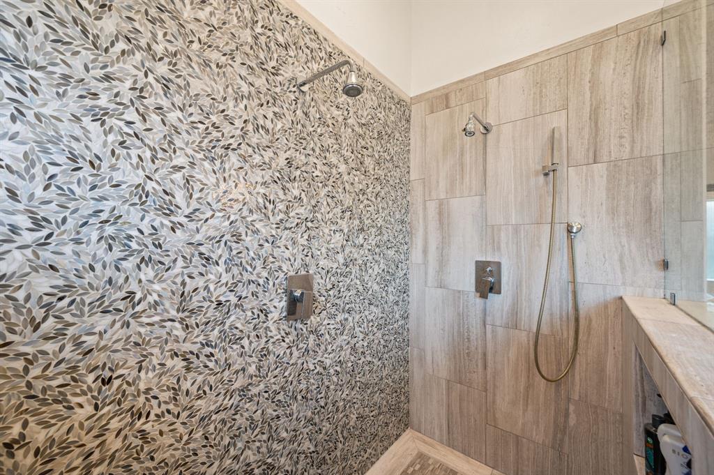 1521 Newton Ranch Road Keller, TX 76248 - Photo 23 of 40 Shower stall featuring a unique mosaic tile wall, large format tile, fixed shower head, and an additional handheld shower fixture