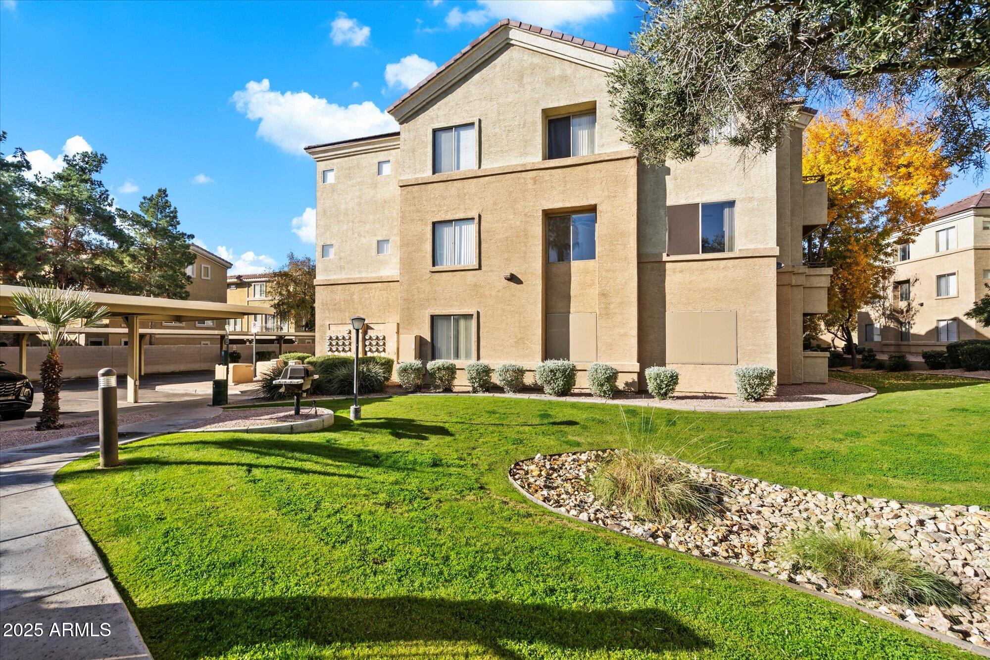 a front view of a house with garden and sitting area