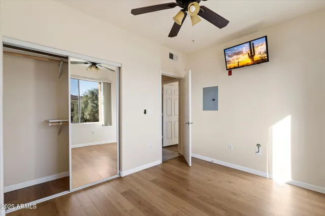 a view of an empty room with wooden floor
