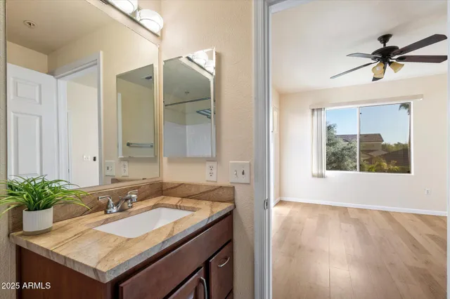 a view of a big room with wooden floor and windows