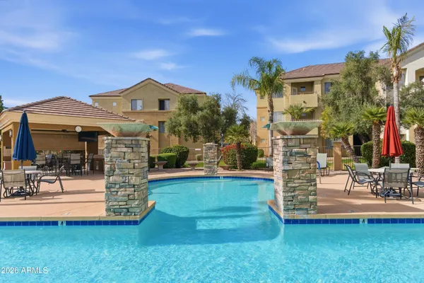 a view of a swimming pool and lounge chairs