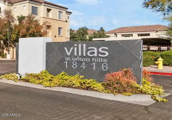 a view of a house with yard and sitting area