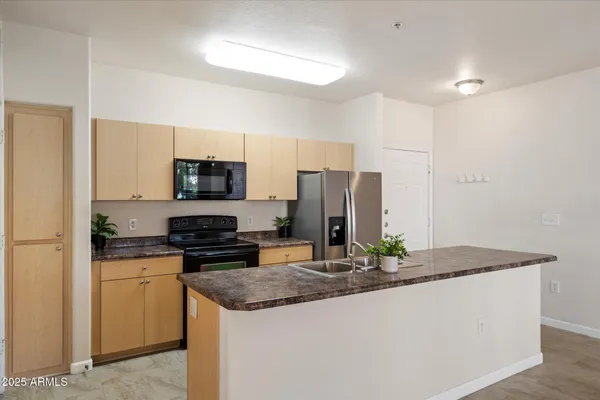 a kitchen that has a sink and a stove