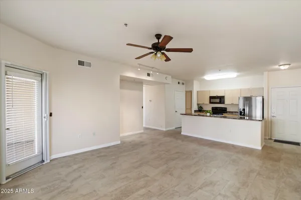 a kitchen with stainless steel appliances granite countertop a stove a sink and a refrigerator