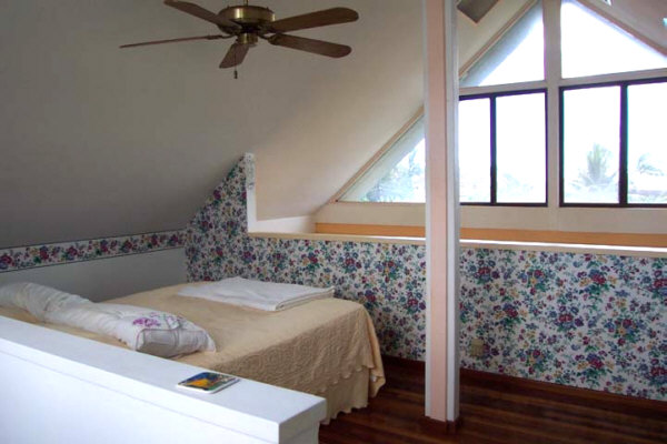 8582 Elepaio Road Kekaha, HI 96752 - Photo 5 of 6 a bedroom with a bed and a window