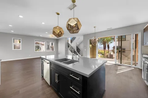 a kitchen with kitchen island stainless steel appliances a sink stove and refrigerator