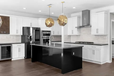 a view of kitchen with wooden floor and electronic appliances