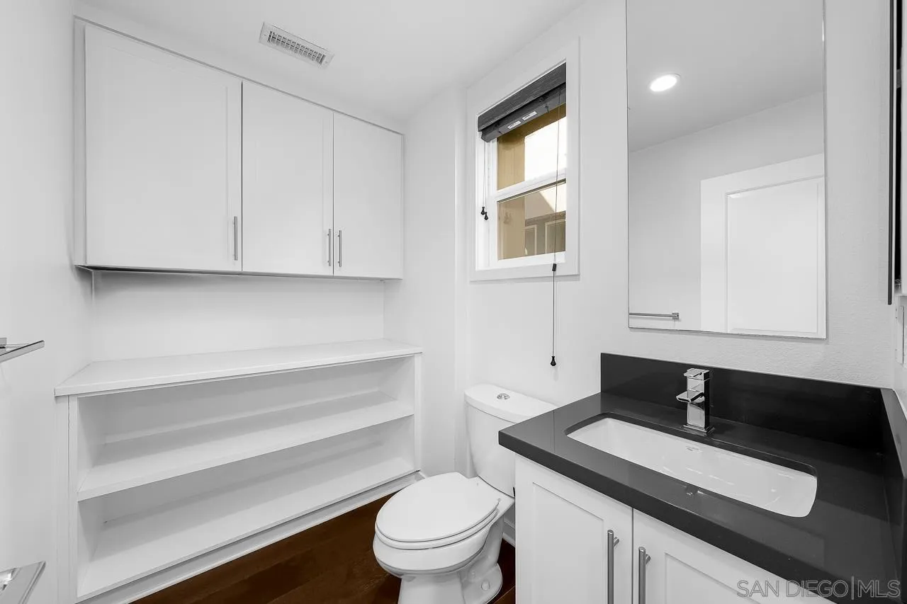 8352 Ridge Court San Diego, CA 92108 - Photo 20 of 68 a bathroom with a sink a toilet and a window