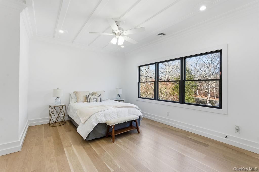 768 Bridgehampton Sag Harbor Bridgehampton, NY 11932 - Photo 15 of 35 Bedroom featuring light wood-style flooring, a ceiling fan, ornamental molding, beamed ceiling, and recessed lighting