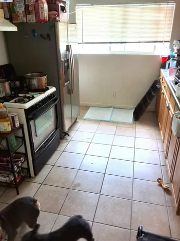 a kitchen with stainless steel appliances a stove a sink and a refrigerator