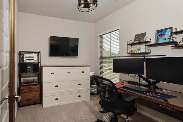 a livingroom with a flat screen tv and a window
