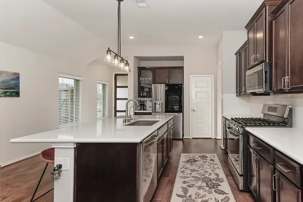 a kitchen with a sink stove and cabinets