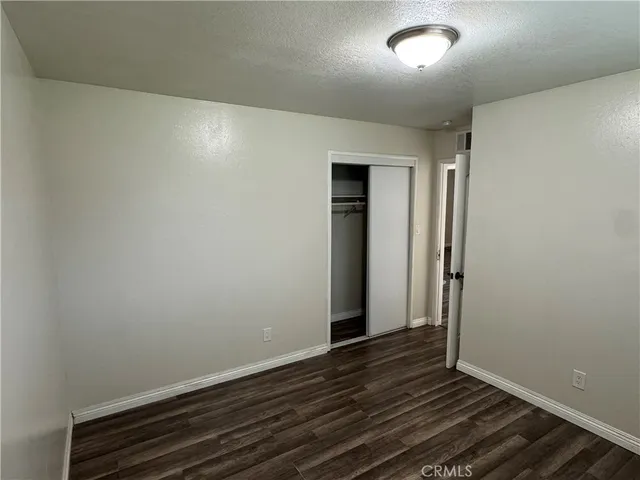 an empty room with wooden floor
